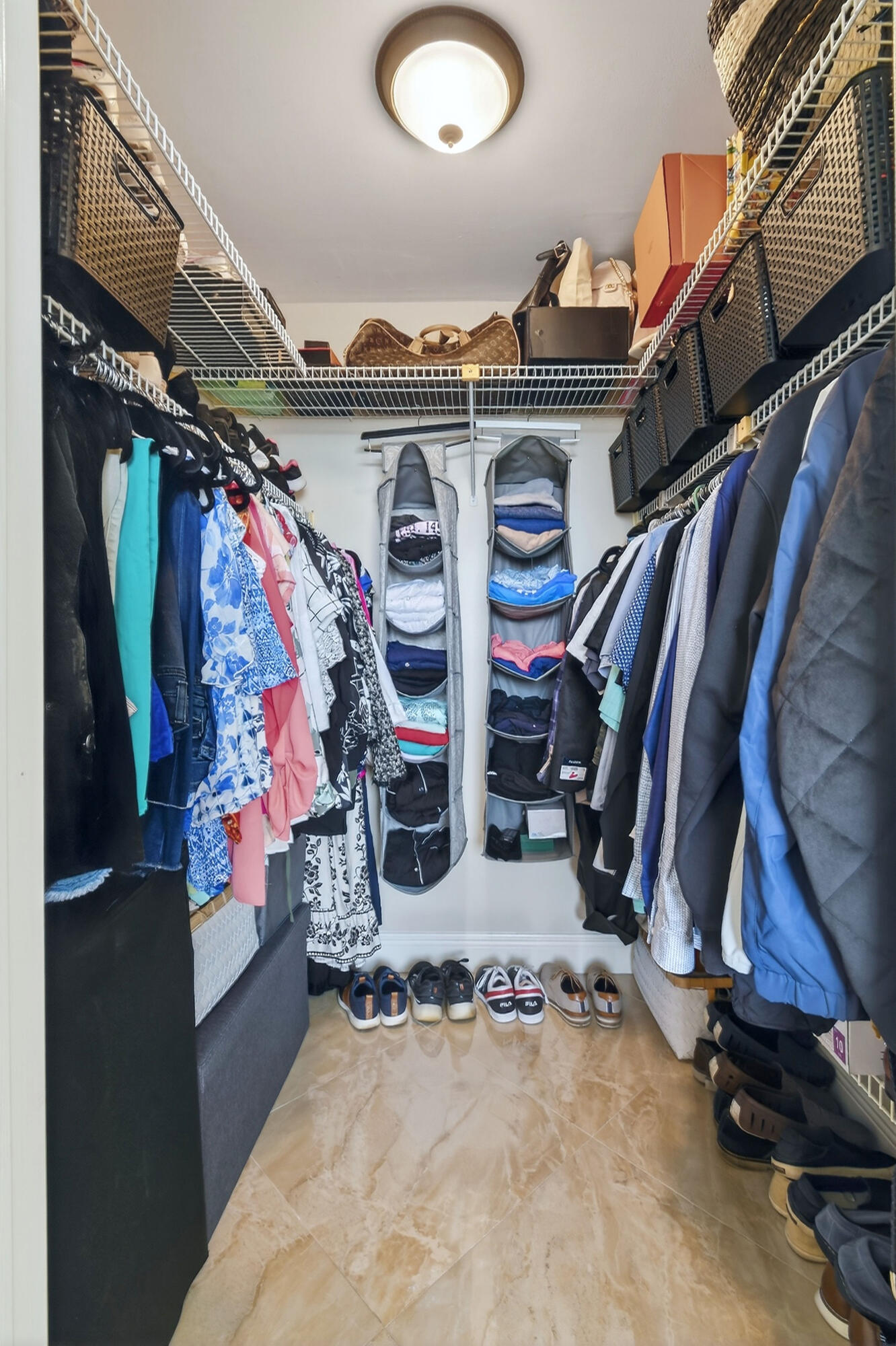 1300 Florida A1A, Unit 320 Jupiter, FL 33477 - Photo 28 of 92 a view of walk in closet with clothes and shoes