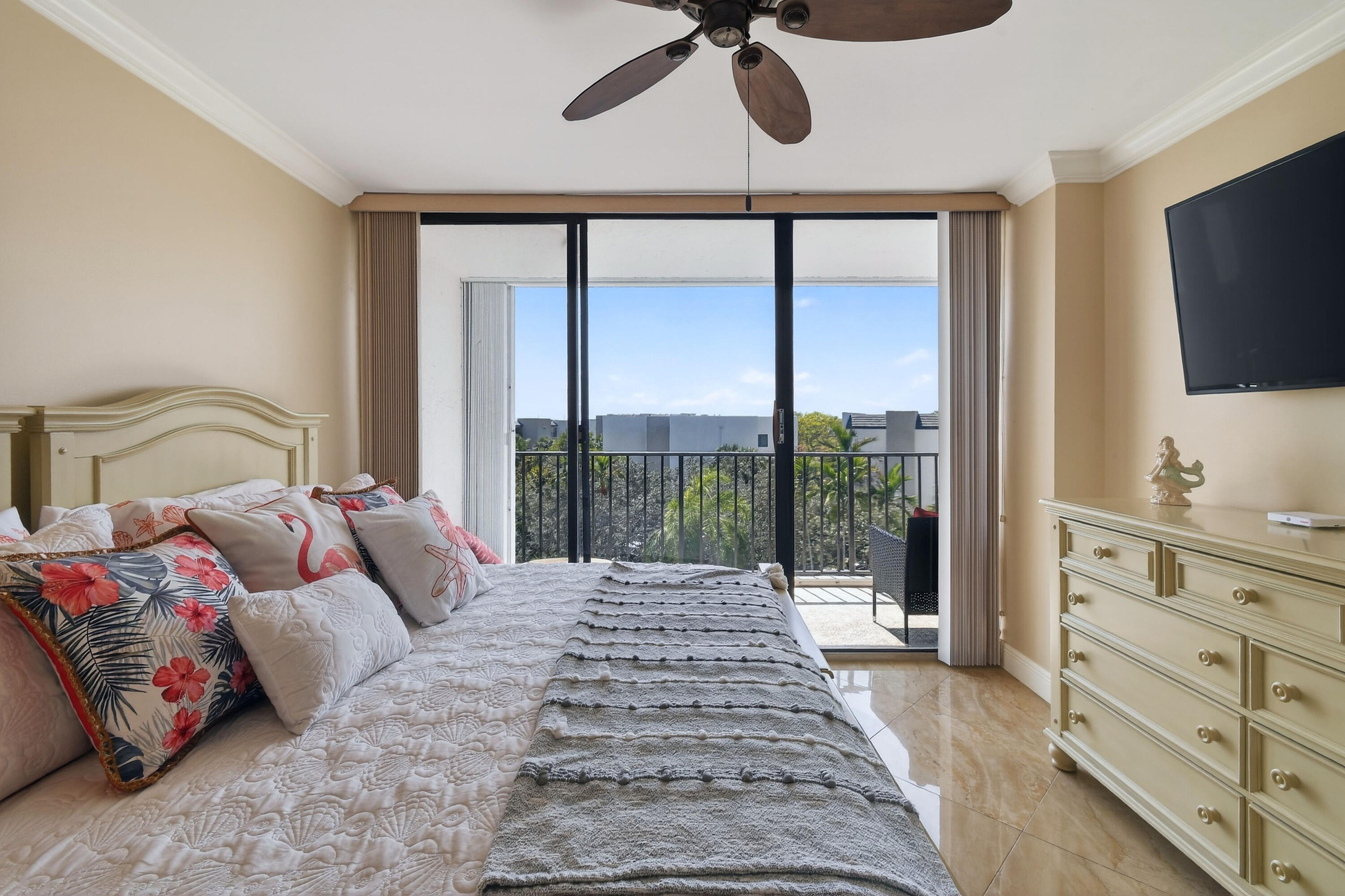 1300 Florida A1A, Unit 320 Jupiter, FL 33477 - Photo 30 of 92 a bedroom with a large bed and a flat tv screen on dresser