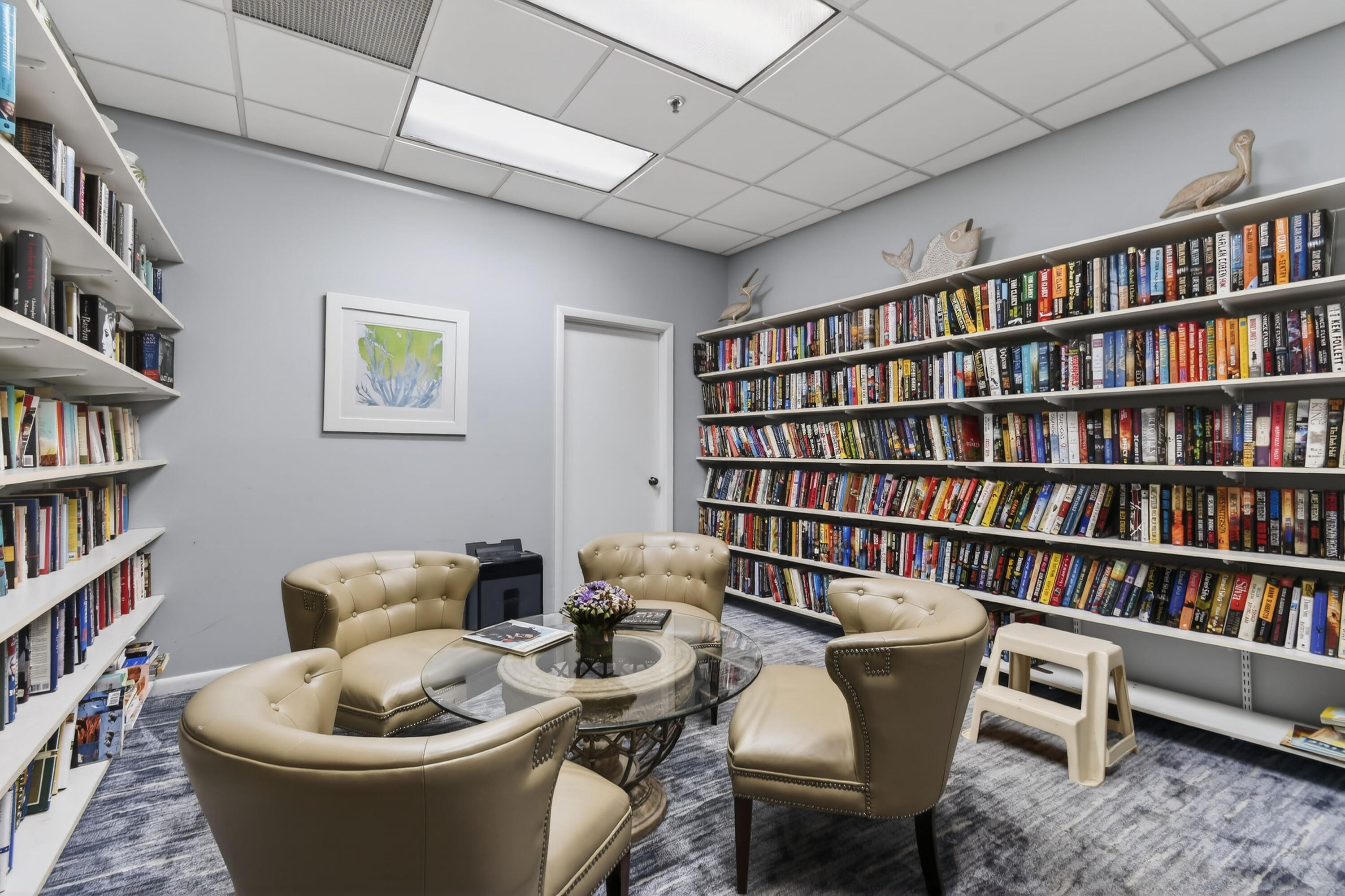 1300 Florida A1A, Unit 320 Jupiter, FL 33477 - Photo 58 of 92 a living room with furniture and a book shelf