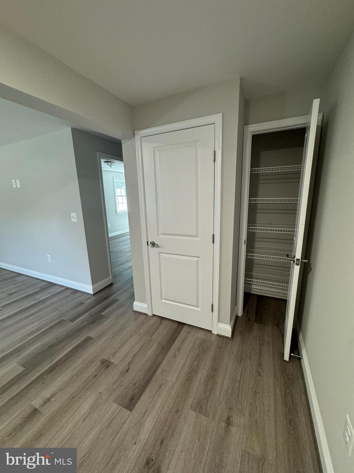 1103 Llano Drive, Unit B La Plata, MD 20646 - Photo 8 of 13 an empty room with wooden floor and closet