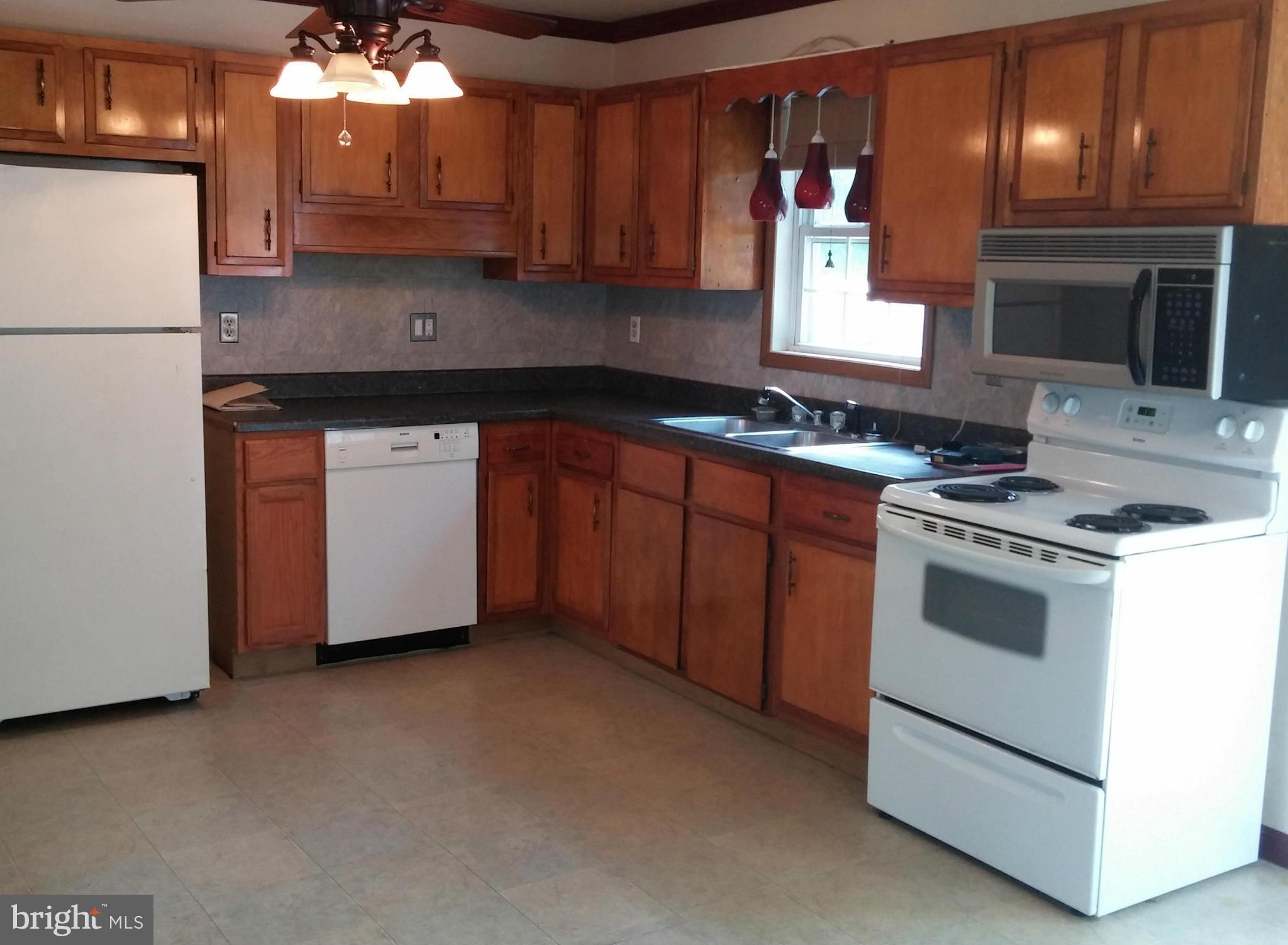 14807 Bottom Road Williamsport, MD 21795 - Photo 8 of 30 a kitchen with stainless steel appliances granite countertop a stove a sink and a refrigerator