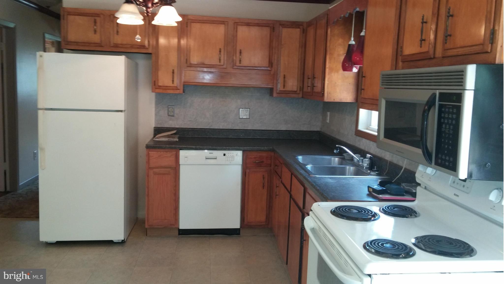 14807 Bottom Road Williamsport, MD 21795 - Photo 9 of 30 a kitchen with a sink and a refrigerator