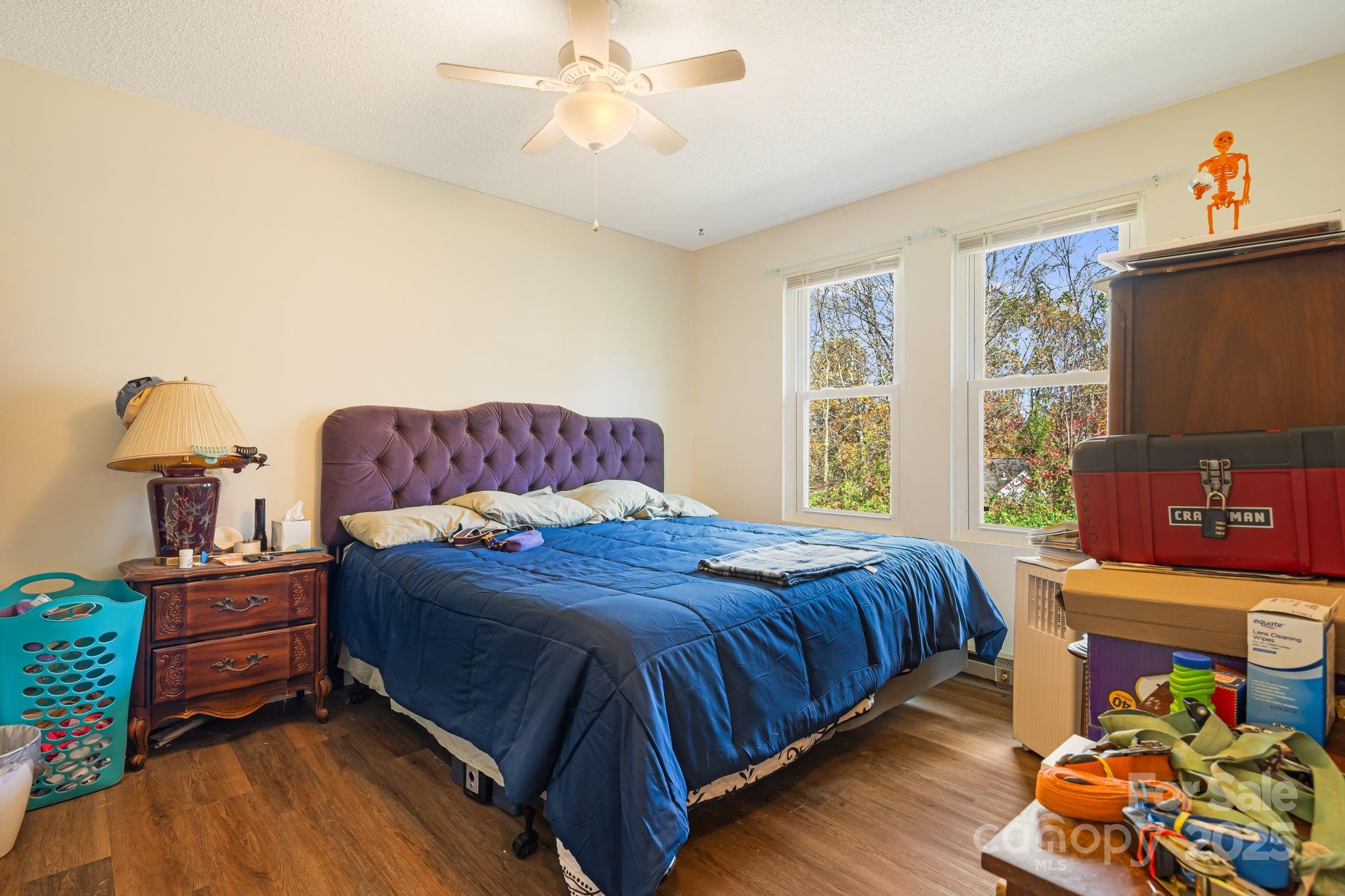 645 Flint Hill Road Alexander, NC 28701 - Photo 13 of 30 a bedroom with a bed and wooden floor