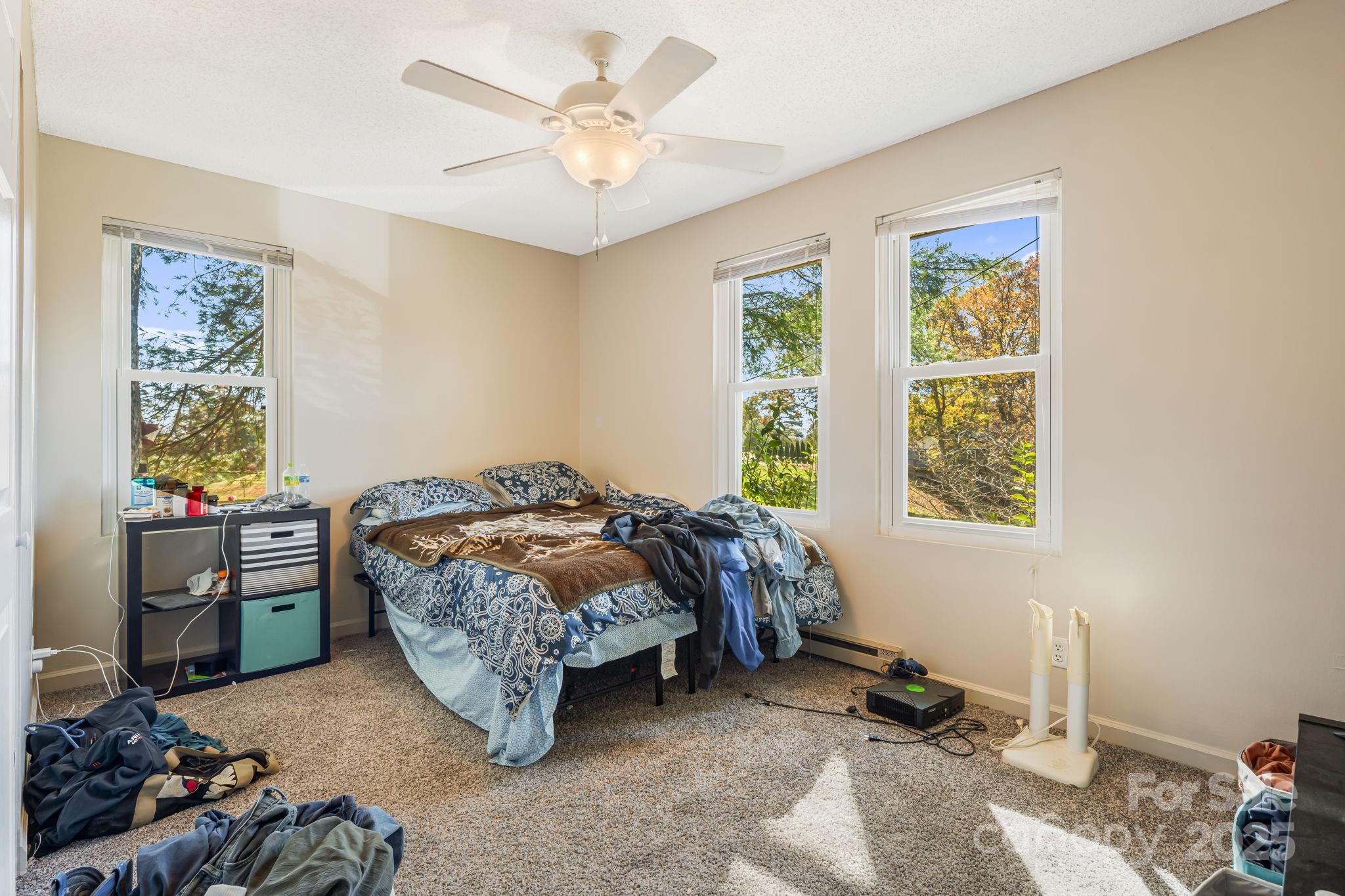 645 Flint Hill Road Alexander, NC 28701 - Photo 21 of 30 a bed room with a bed and a window