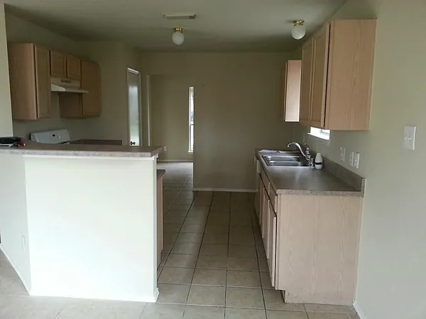 a kitchen with a refrigerator sink and stove