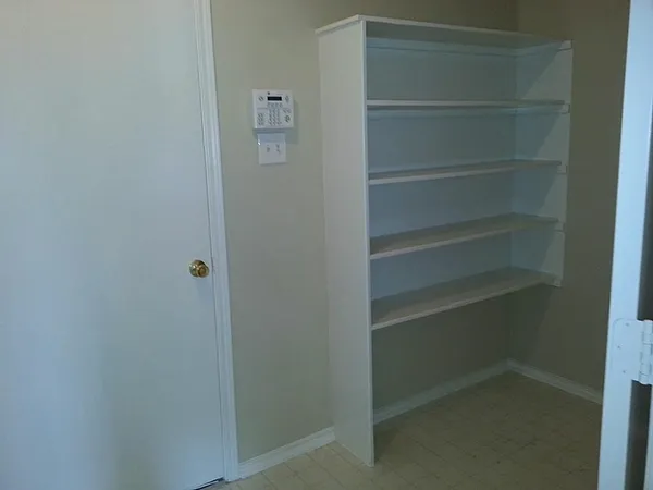 a view of walk in closet with empty racks