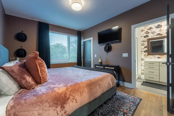 a bedroom with a bed and glass windows