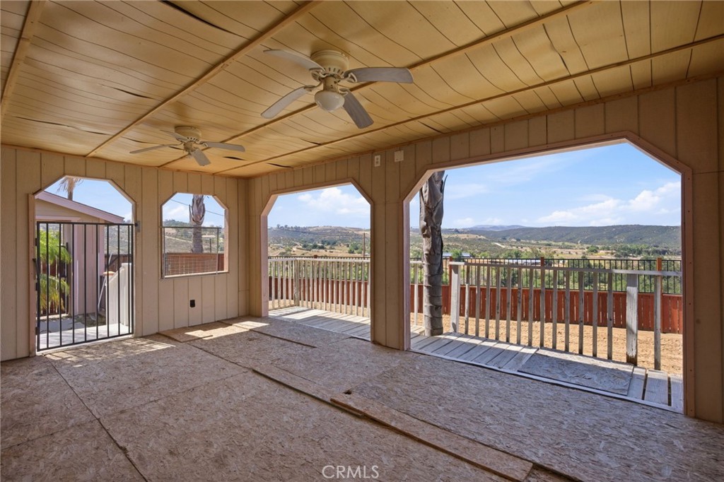 40100 Owl Valley Road Temecula, CA 92592 - Photo 32 of 44 a view of a porch with furniture and floor to ceiling window