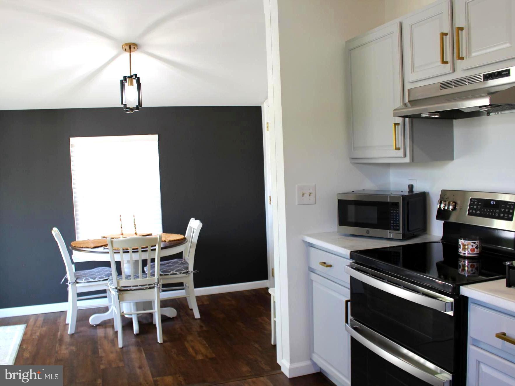 1643 Oldtown Road Edgewater, MD 21037 - Photo 4 of 8 a kitchen with stainless steel appliances a stove a table and chairs