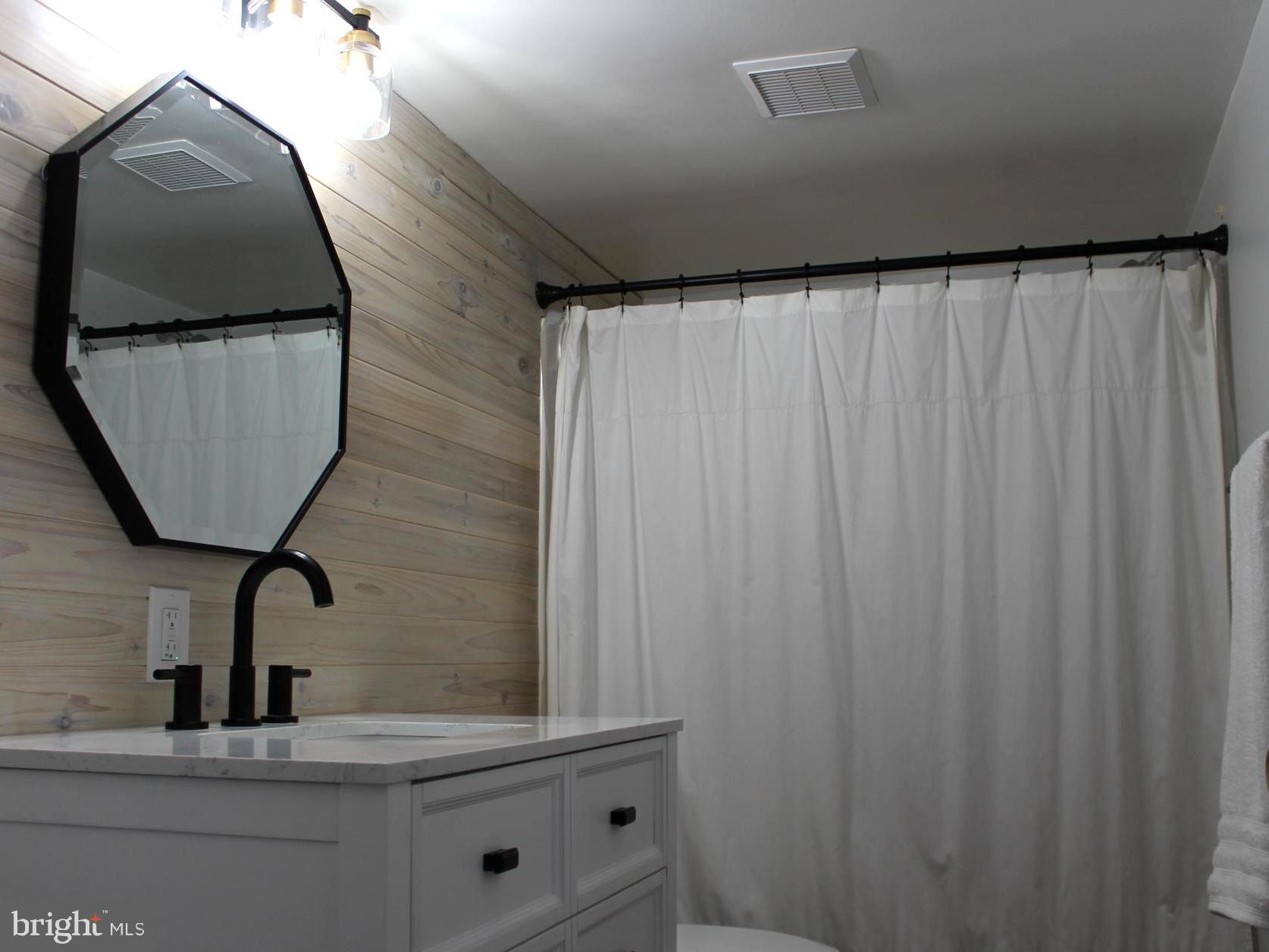 1643 Oldtown Road Edgewater, MD 21037 - Photo 6 of 8 a bathroom with a sink and mirror