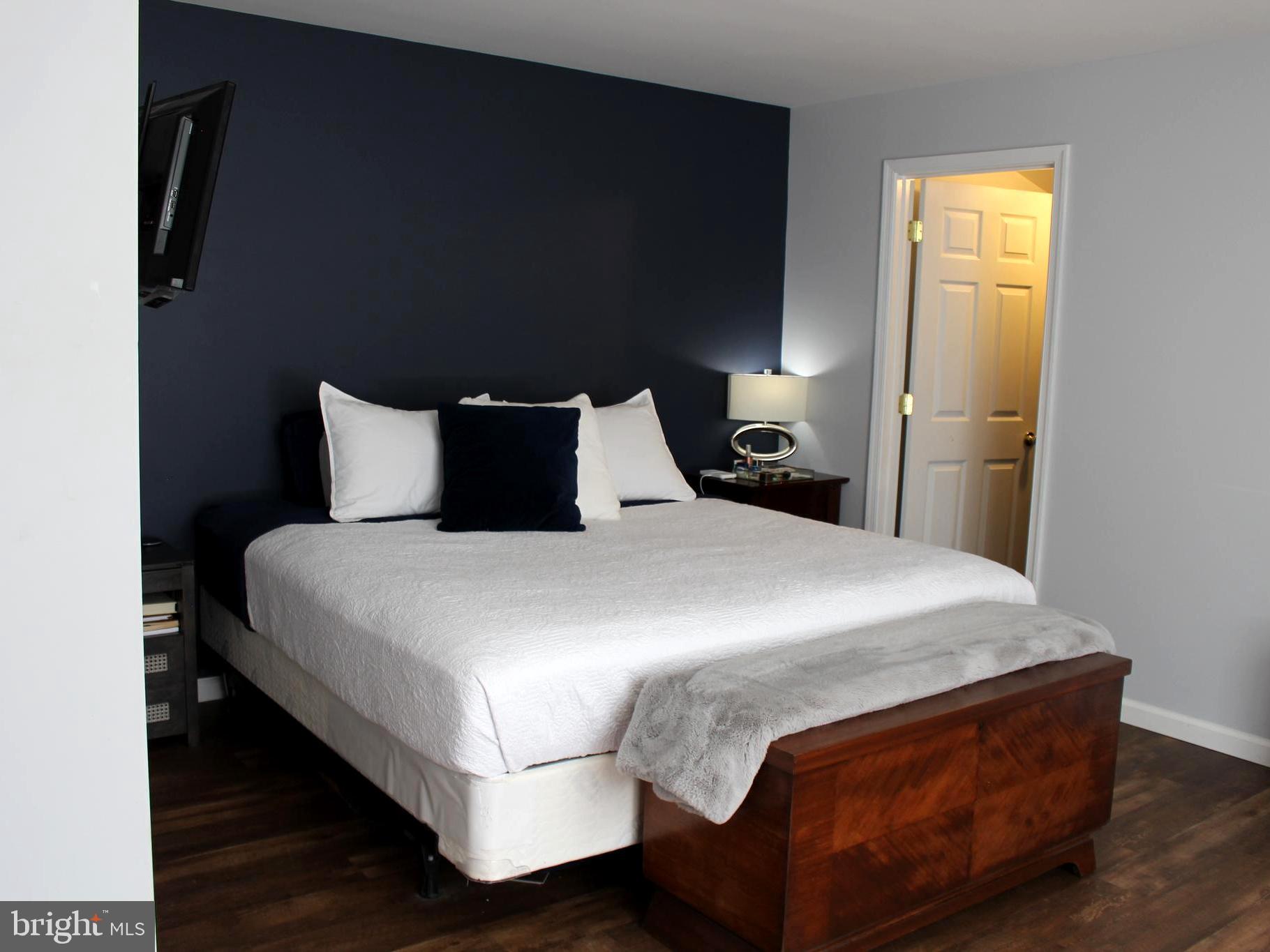 1643 Oldtown Road Edgewater, MD 21037 - Photo 8 of 8 a bedroom with a bed and lamps