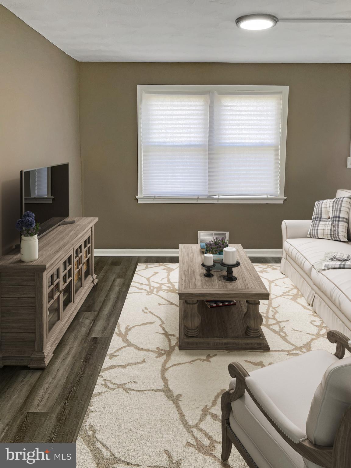 2607 Colebrooke Drive, Unit 21 Temple Hills, MD 20748 - Photo 2 of 9 a living room with furniture and a flat screen tv