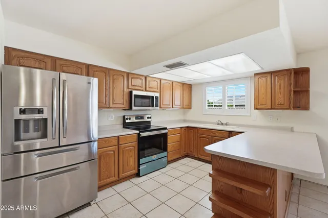 a kitchen with stainless steel appliances granite countertop a stove microwave and refrigerator