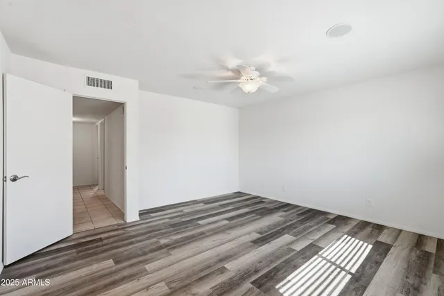 a view of a room with a ceiling fan