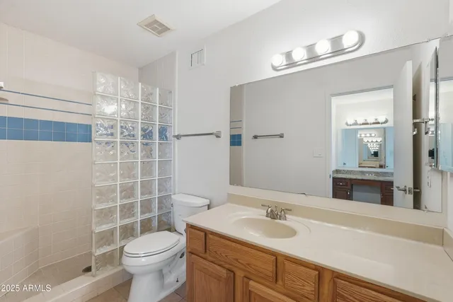 a bathroom with a toilet and shower