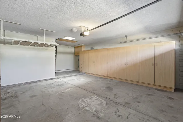 a view of a patio with table and chairs with wooden fence and plants