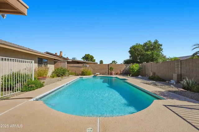 a view of a house with a yard and sitting area