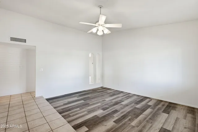 a view of a room with wooden floor and white walls