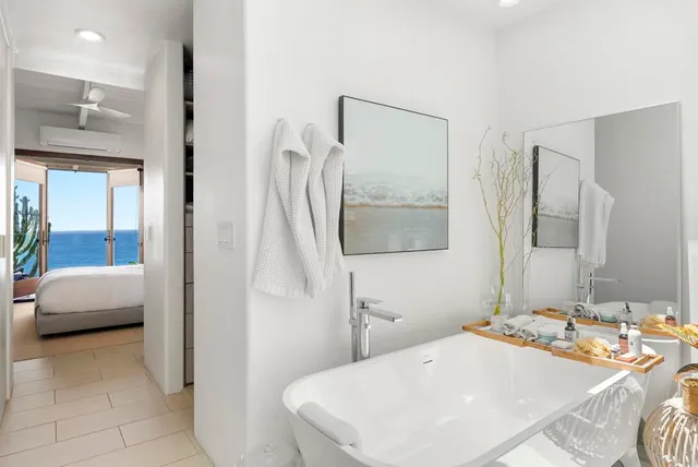 a bedroom with a bed and a mirror