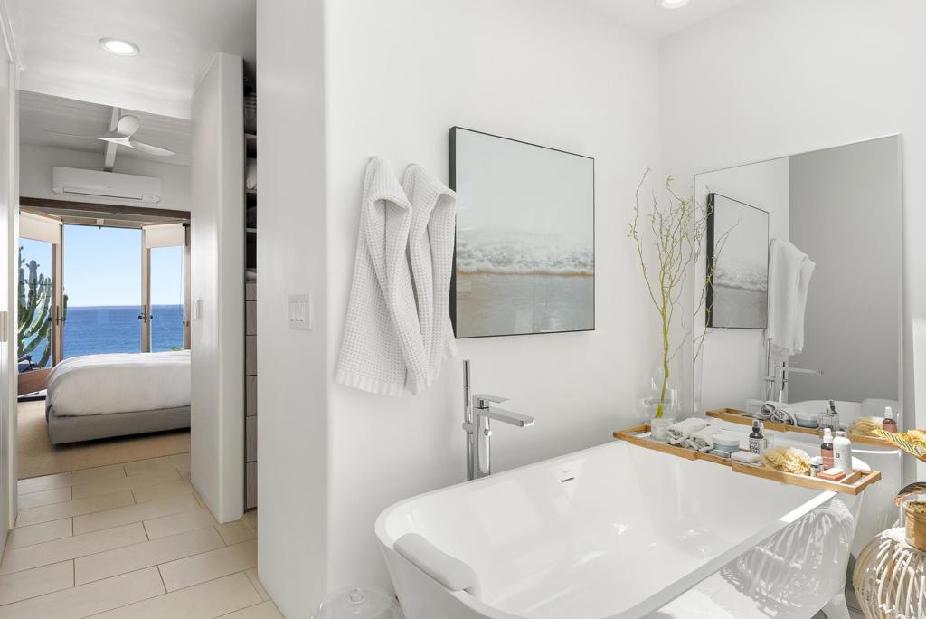 1370 Neptune Avenue Encinitas, CA 92024 - Photo 12 of 31 a bedroom with a bed and a mirror