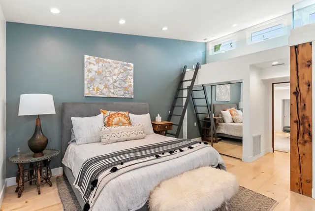 a bedroom with a large bed and a lamp