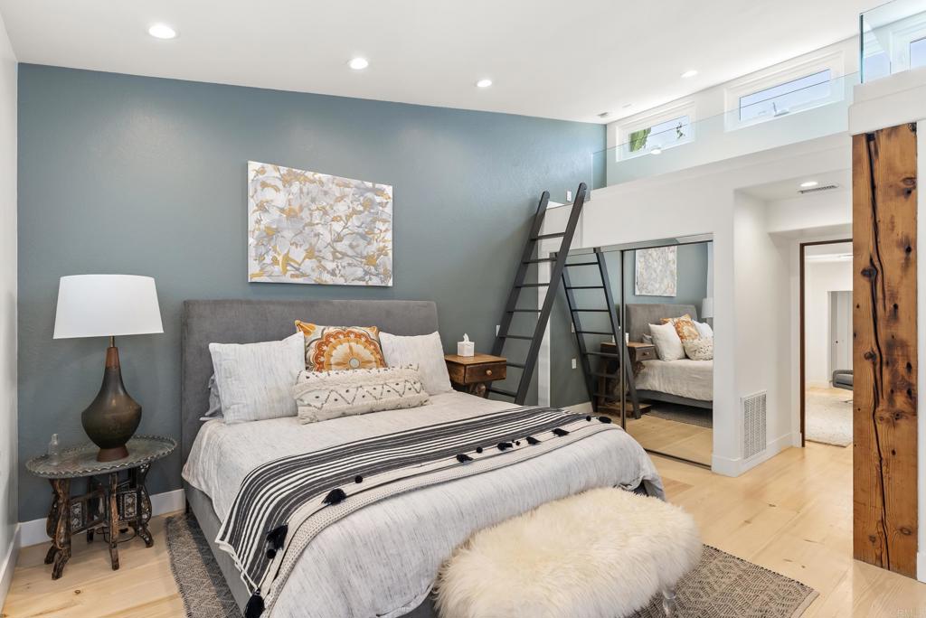 1370 Neptune Avenue Encinitas, CA 92024 - Photo 15 of 31 a bedroom with a large bed and a lamp