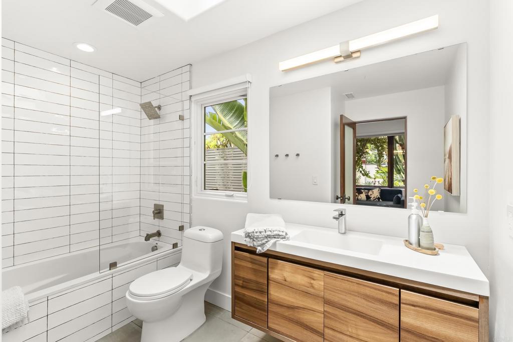 1370 Neptune Avenue Encinitas, CA 92024 - Photo 16 of 31 a bathroom with a double vanity sink toilet mirror and bathtub