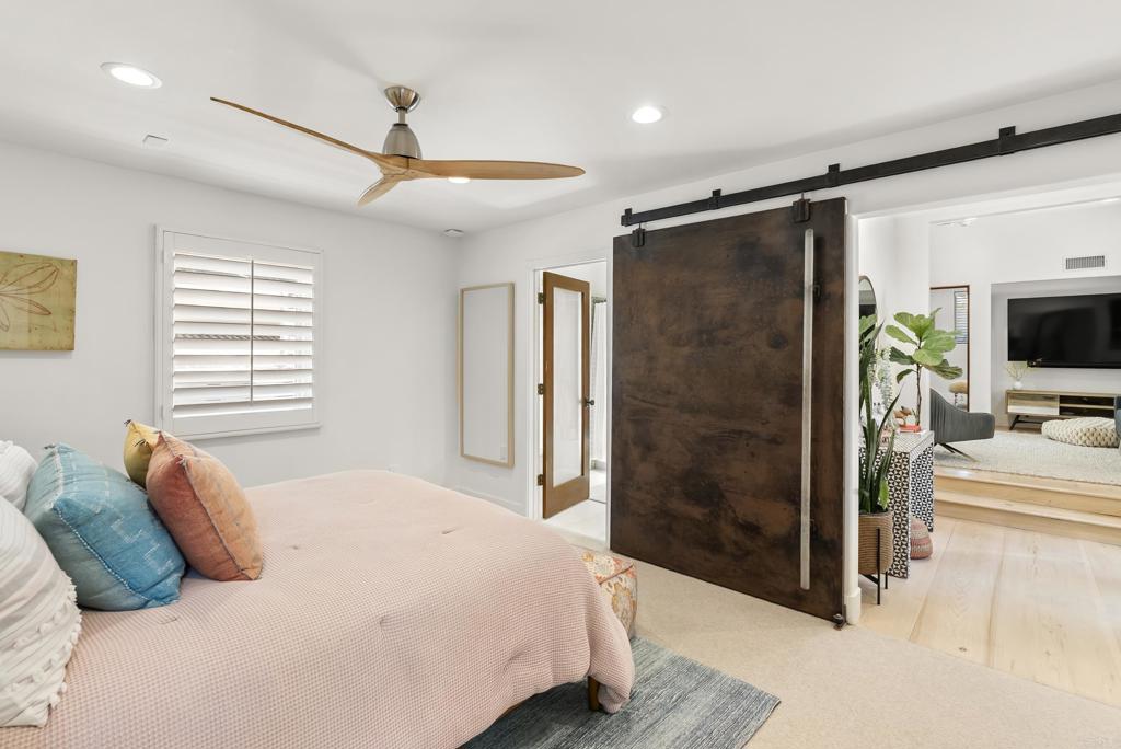 1370 Neptune Avenue Encinitas, CA 92024 - Photo 20 of 31 a bedroom with a bed and a flat screen tv