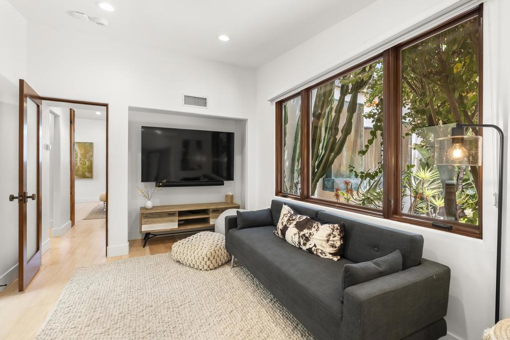 1370 Neptune Avenue Encinitas, CA 92024 - Photo 22 of 31 a living room with furniture and a flat screen tv