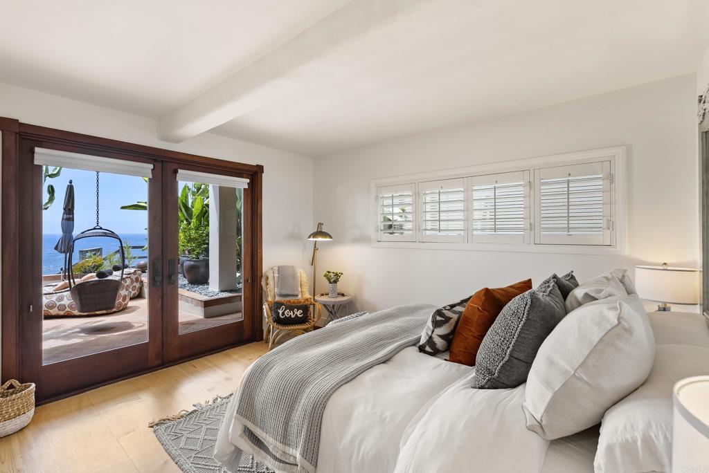 1370 Neptune Avenue Encinitas, CA 92024 - Photo 23 of 31 a bedroom with a bed and glass door
