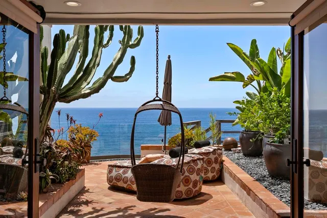 a vase of flowers sitting on a table in front of a door