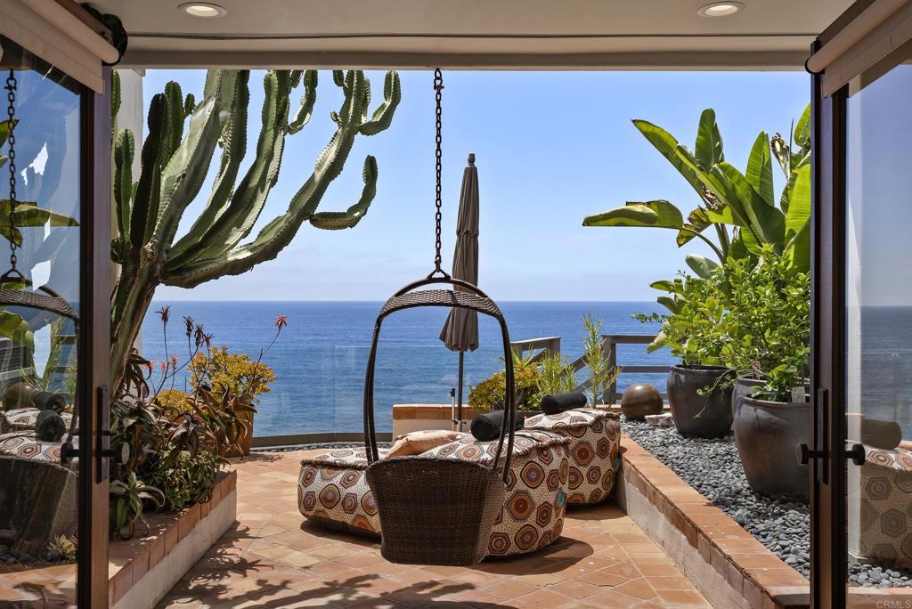 1370 Neptune Avenue Encinitas, CA 92024 - Photo 24 of 31 a vase of flowers sitting on a table in front of a door