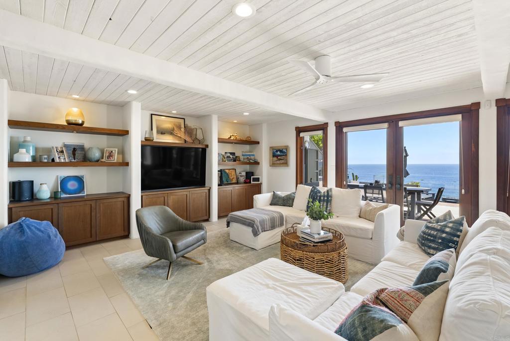 1370 Neptune Avenue Encinitas, CA 92024 - Photo 27 of 31 a living room with furniture a large window and a dining table