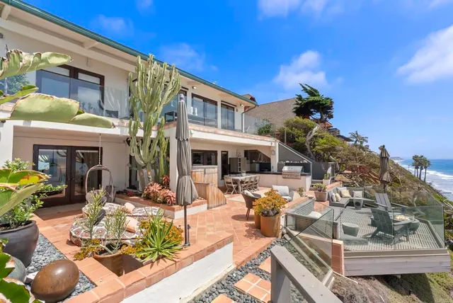 a front view of a house with sitting area