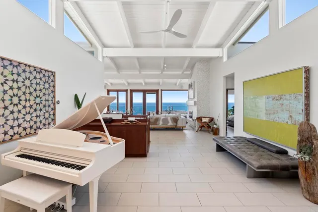 a living room with furniture and a piano