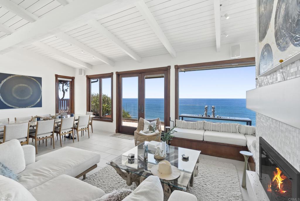 1370 Neptune Avenue Encinitas, CA 92024 - Photo 5 of 31 a living room with furniture and a floor to ceiling window