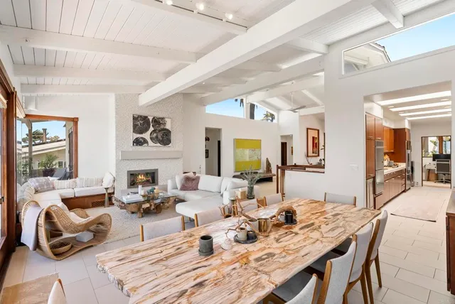 a living room with fireplace furniture and a large window