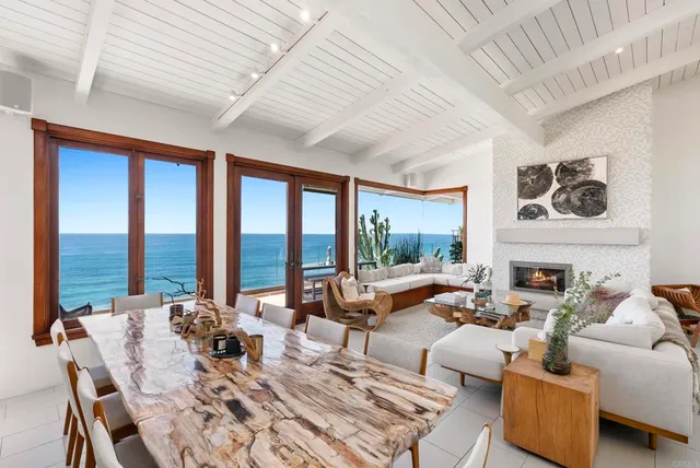 a living room with furniture large windows and a table