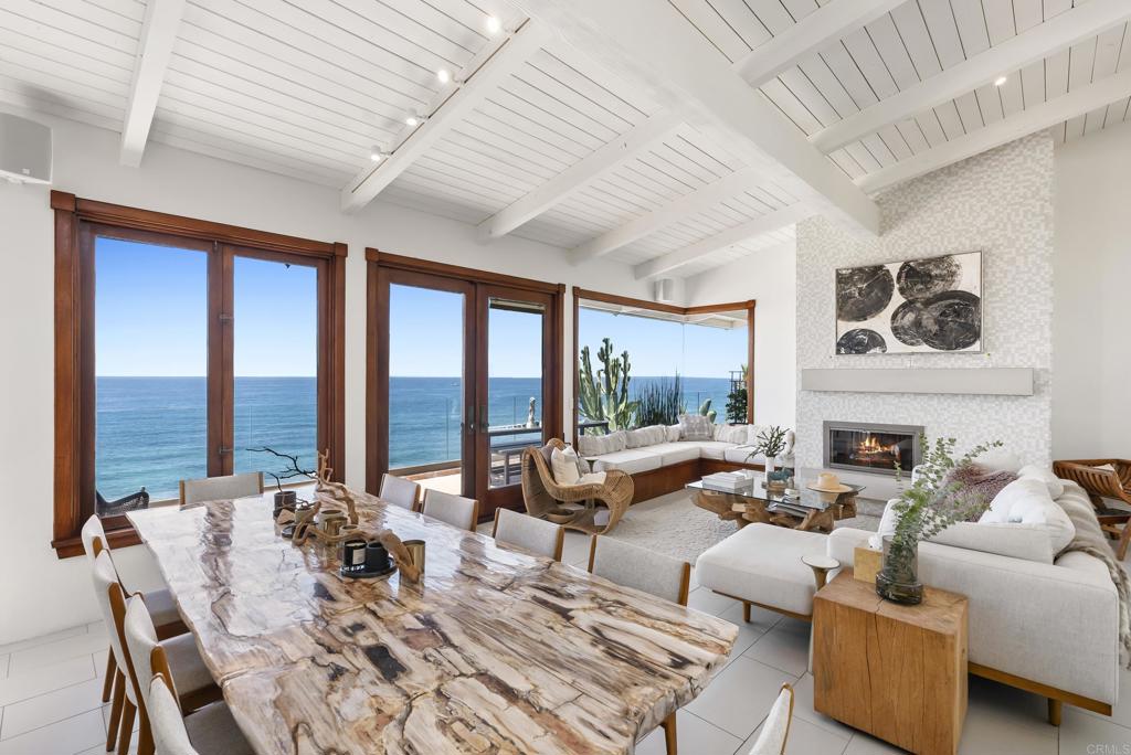 1370 Neptune Avenue Encinitas, CA 92024 - Photo 7 of 31 a living room with furniture large windows and a table
