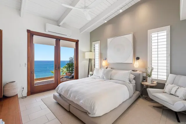 a bedroom with a bed and a large window