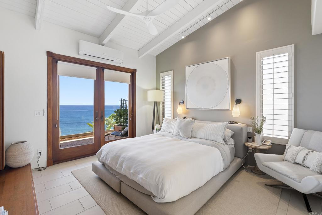 1370 Neptune Avenue Encinitas, CA 92024 - Photo 9 of 31 a bedroom with a bed and a large window