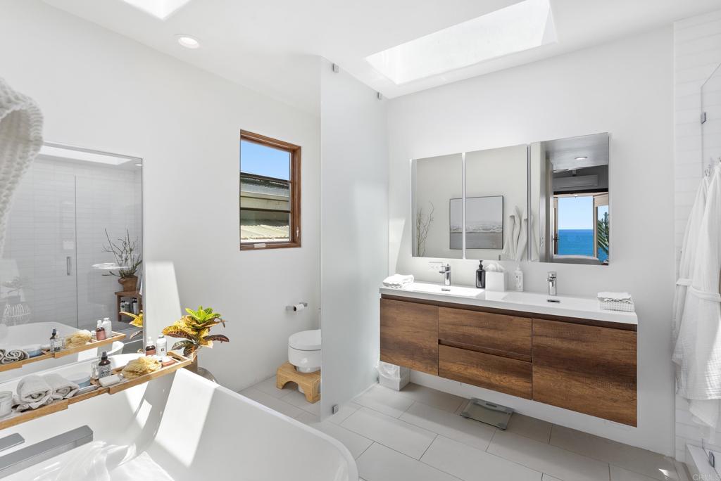 1370 Neptune Avenue Encinitas, CA 92024 - Photo 10 of 31 a bathroom with a tub sink and mirror