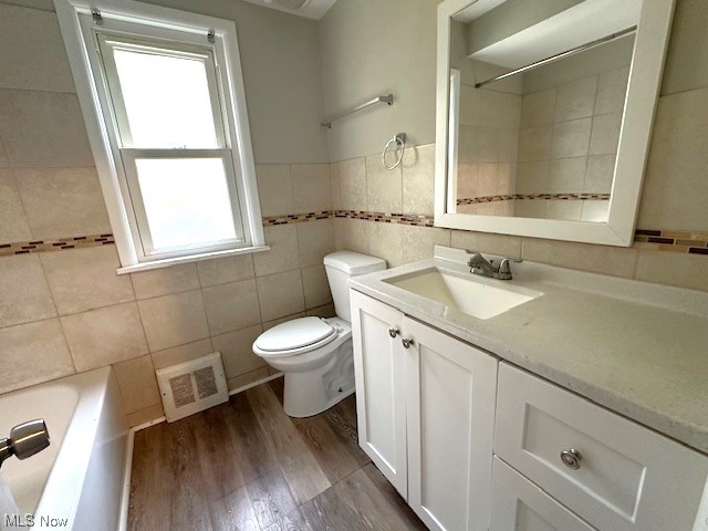 4230 Bluestone Road South Euclid, OH 44121 - Photo 17 of 35 Full bathroom with toilet, tile walls, wood-type flooring, shower / bath combination, and vanity