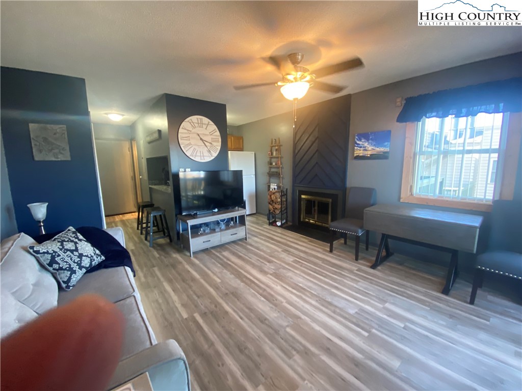 301 Pinnacle Inn Road, Unit 1306 Beech Mountain, NC 28604 - Photo 6 of 19 a living room with furniture a window and a fireplace