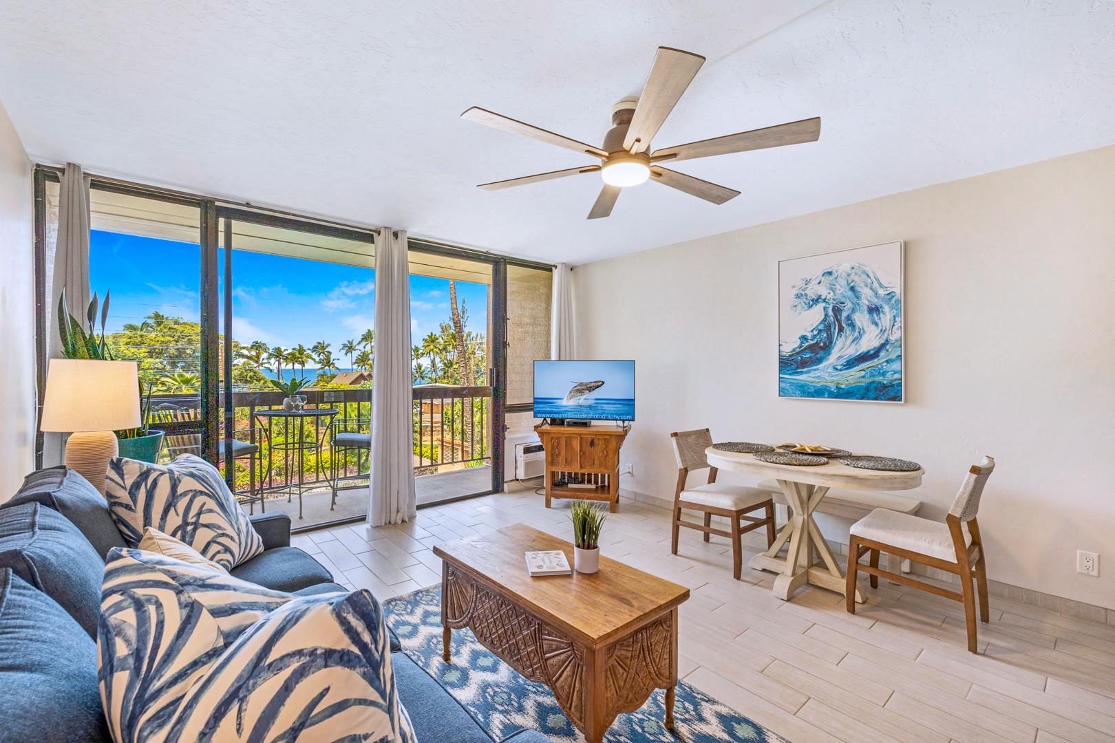 a living room with fireplace furniture and a large window