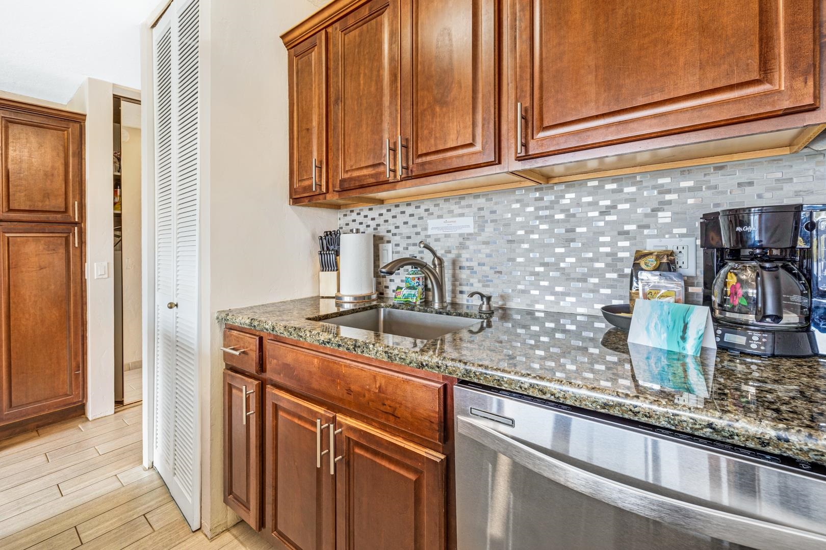 2191 South Kihei Road, Unit 1305 Kihei, HI 96753 - Photo 13 of 21 a kitchen with stainless steel appliances granite countertop a sink and cabinets