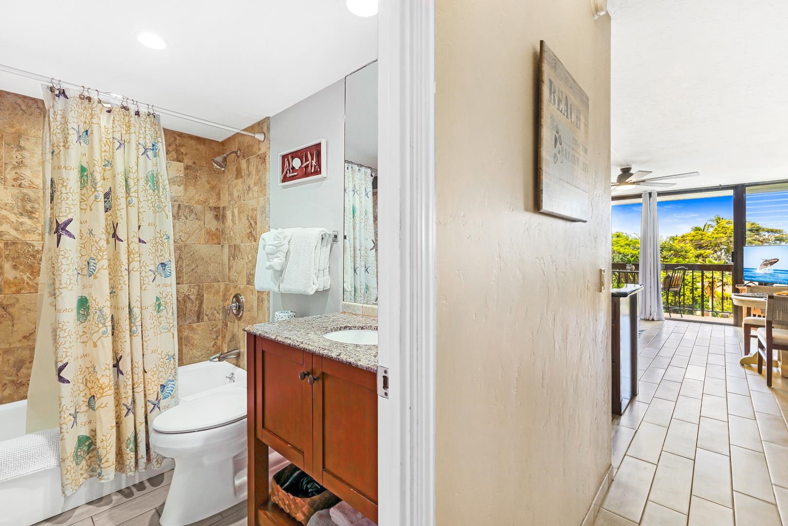 2191 South Kihei Road, Unit 1305 Kihei, HI 96753 - Photo 14 of 21 a bathroom with a granite countertop sink a toilet and shower