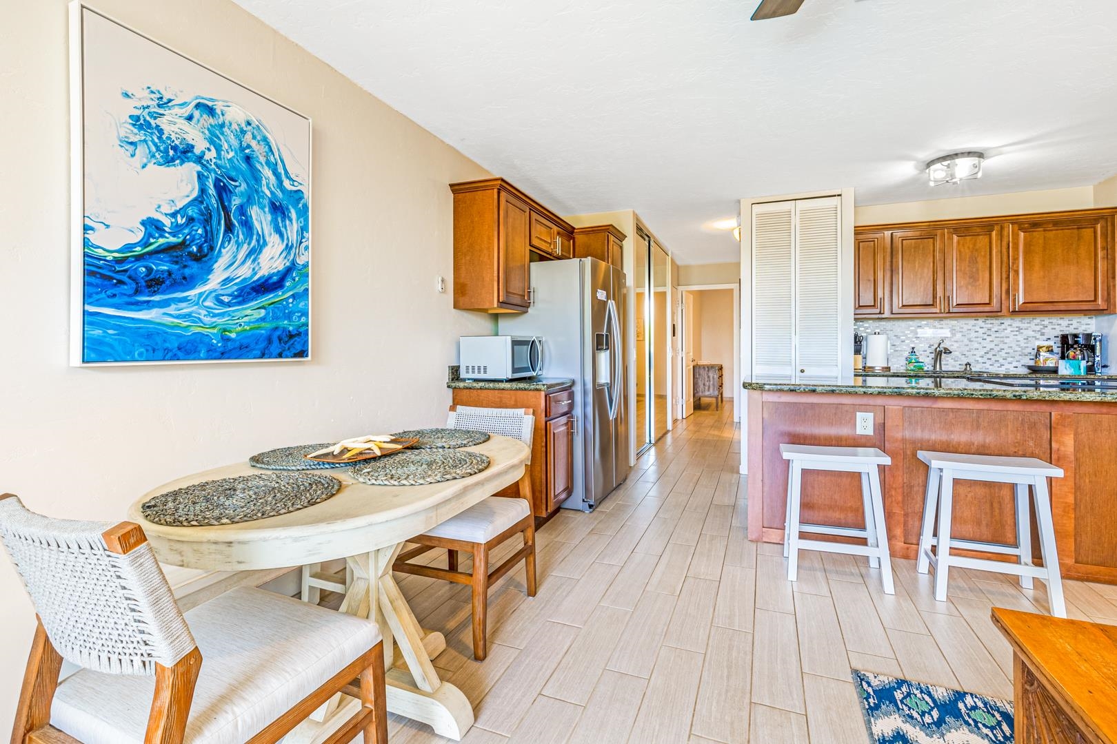 2191 South Kihei Road, Unit 1305 Kihei, HI 96753 - Photo 2 of 21 a dining room with furniture and wooden floor