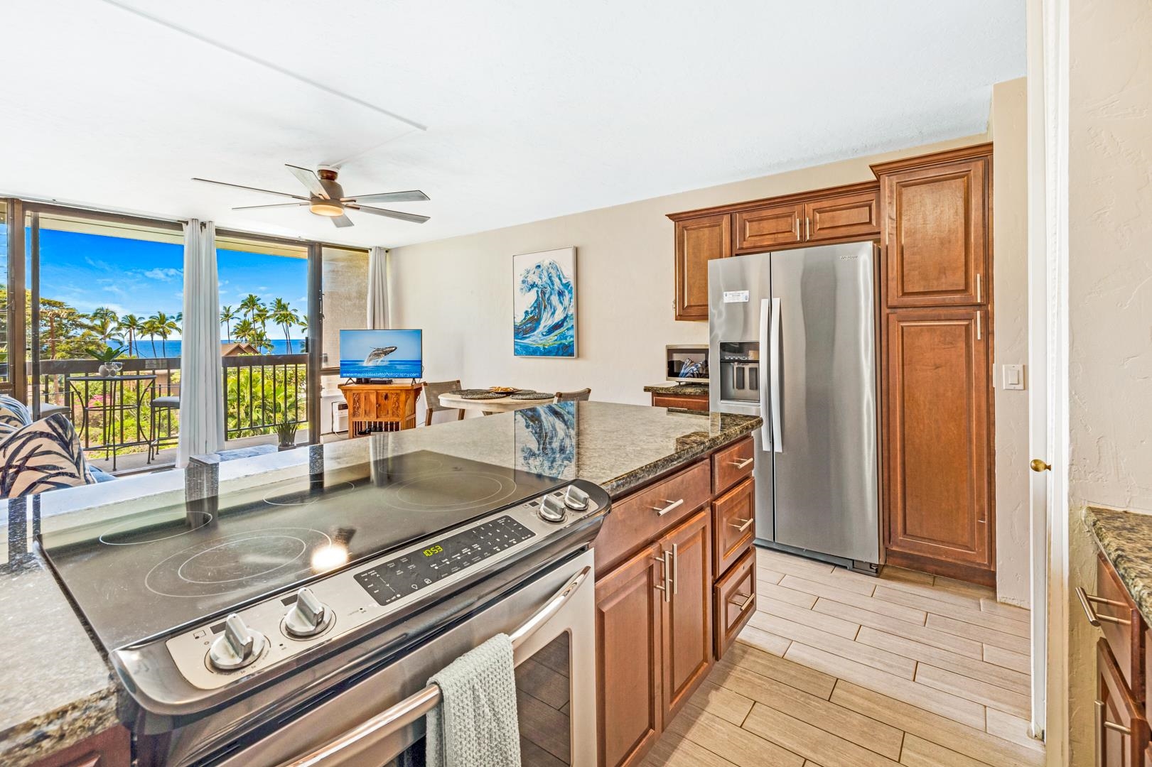 2191 South Kihei Road, Unit 1305 Kihei, HI 96753 - Photo 6 of 21 a kitchen with stainless steel appliances granite countertop a stove top oven a sink and a refrigerator