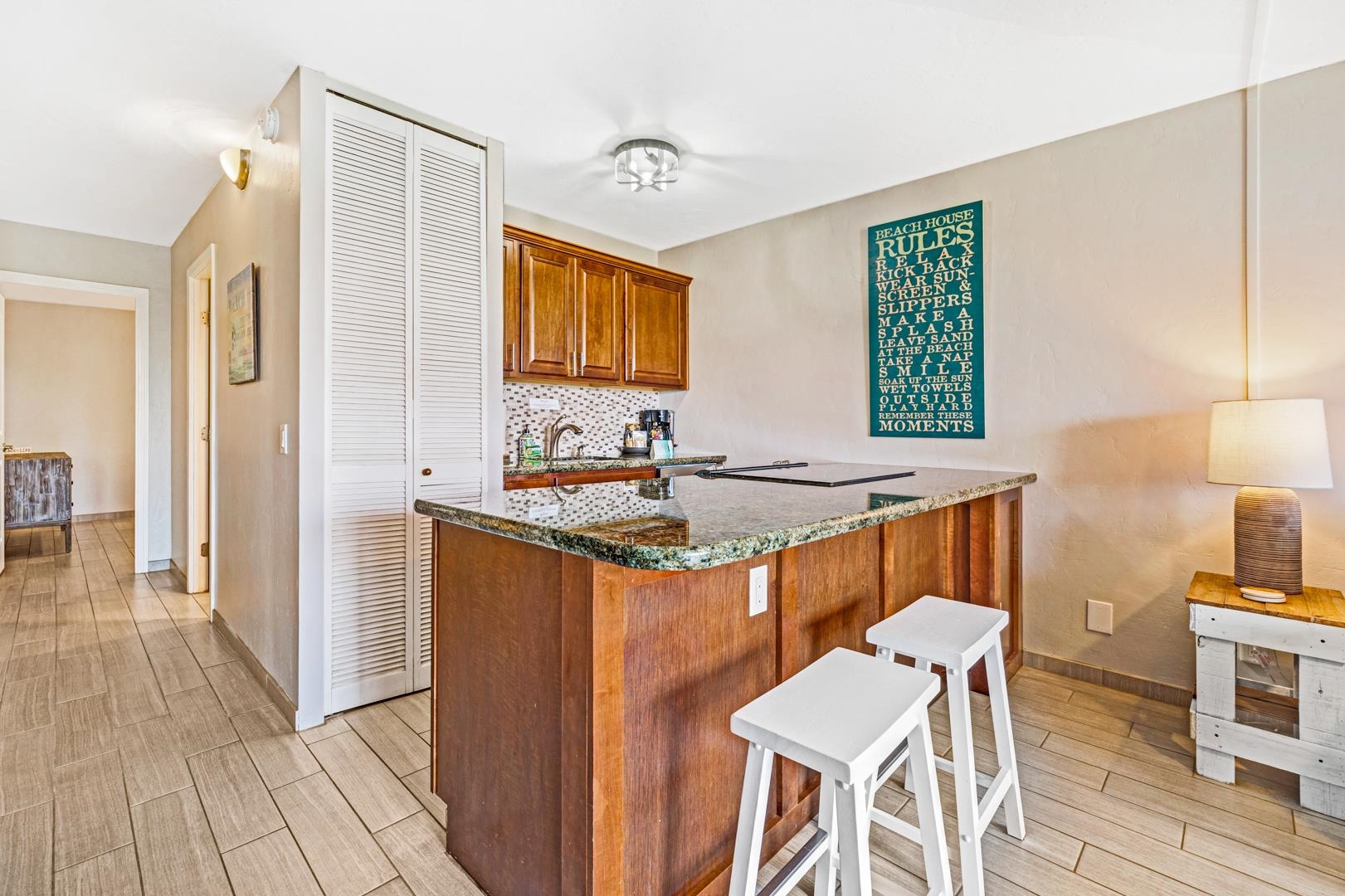 2191 South Kihei Road, Unit 1305 Kihei, HI 96753 - Photo 8 of 21 a kitchen with stainless steel appliances granite countertop a stove a sink and a refrigerator